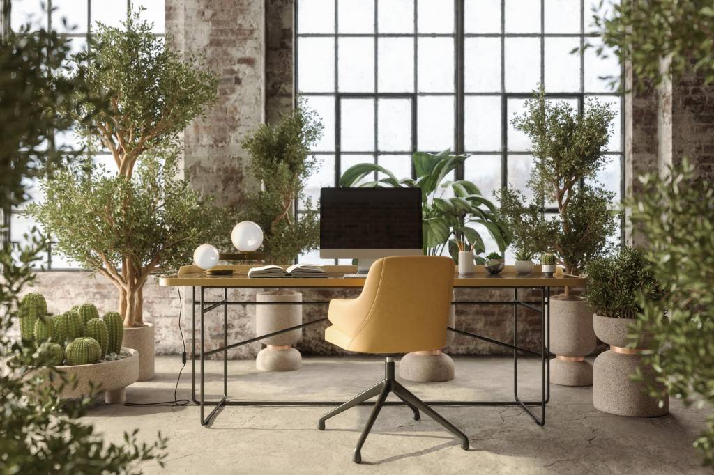 imagem de uma mesa com computador no meio de uma sala com plantas